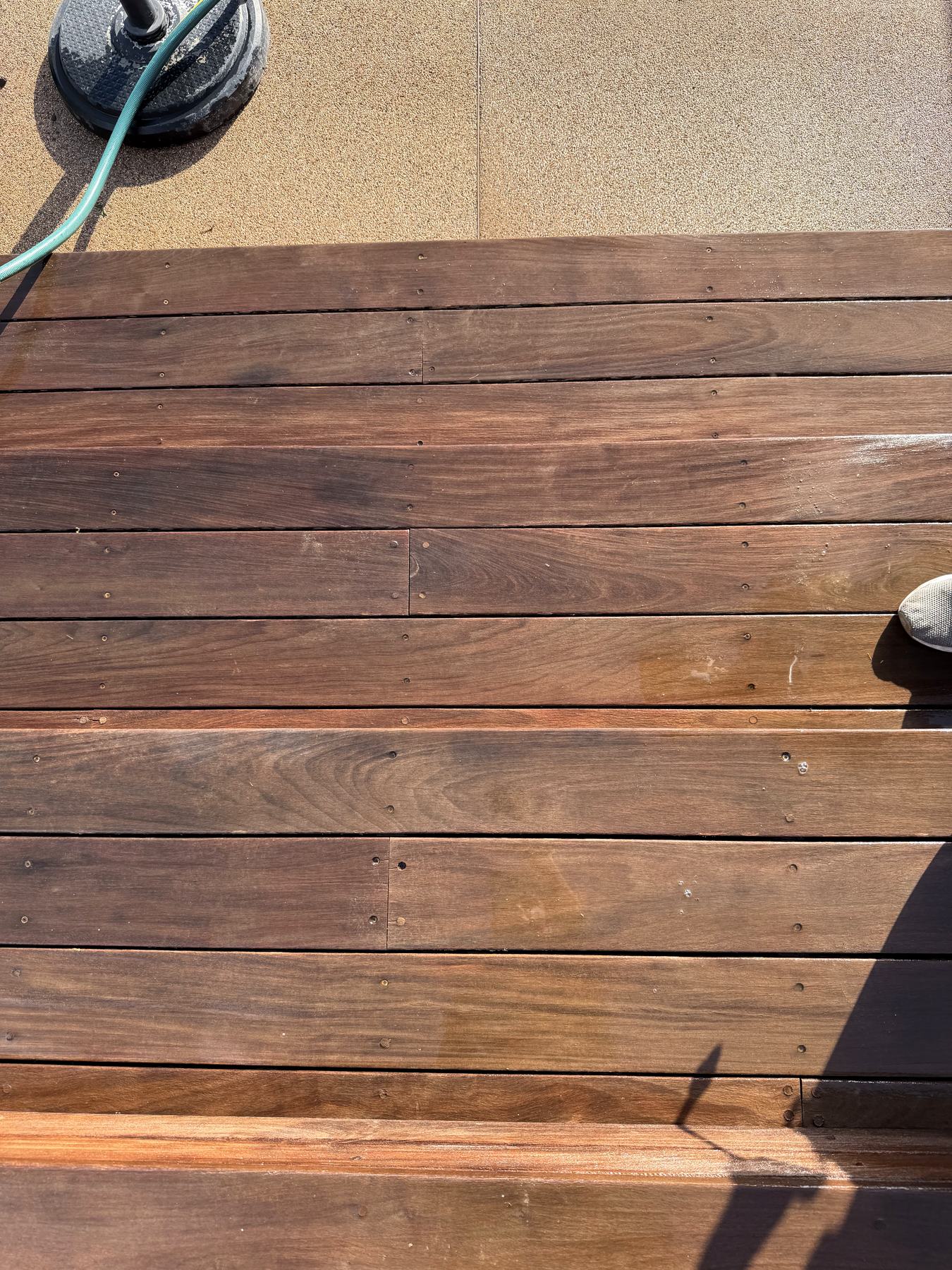 After: deck boards restored to a warm, rich tone.