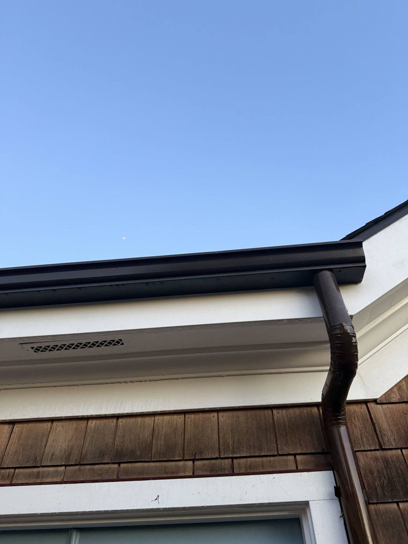 A clean, clear gutter and downspout along the roofline of a Santa Barbara home.