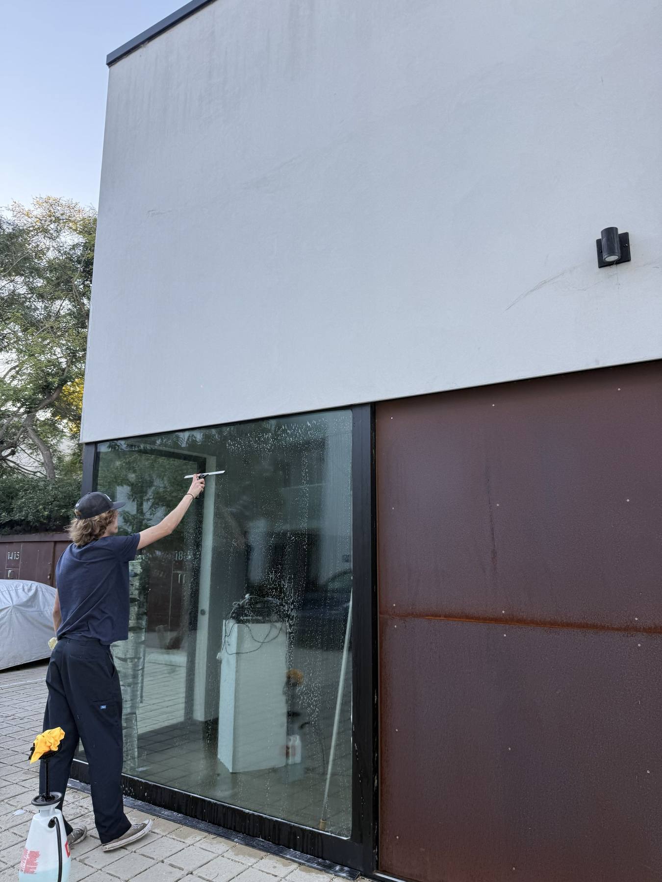 Large glass panel on a modern Montecito home being cleaned.