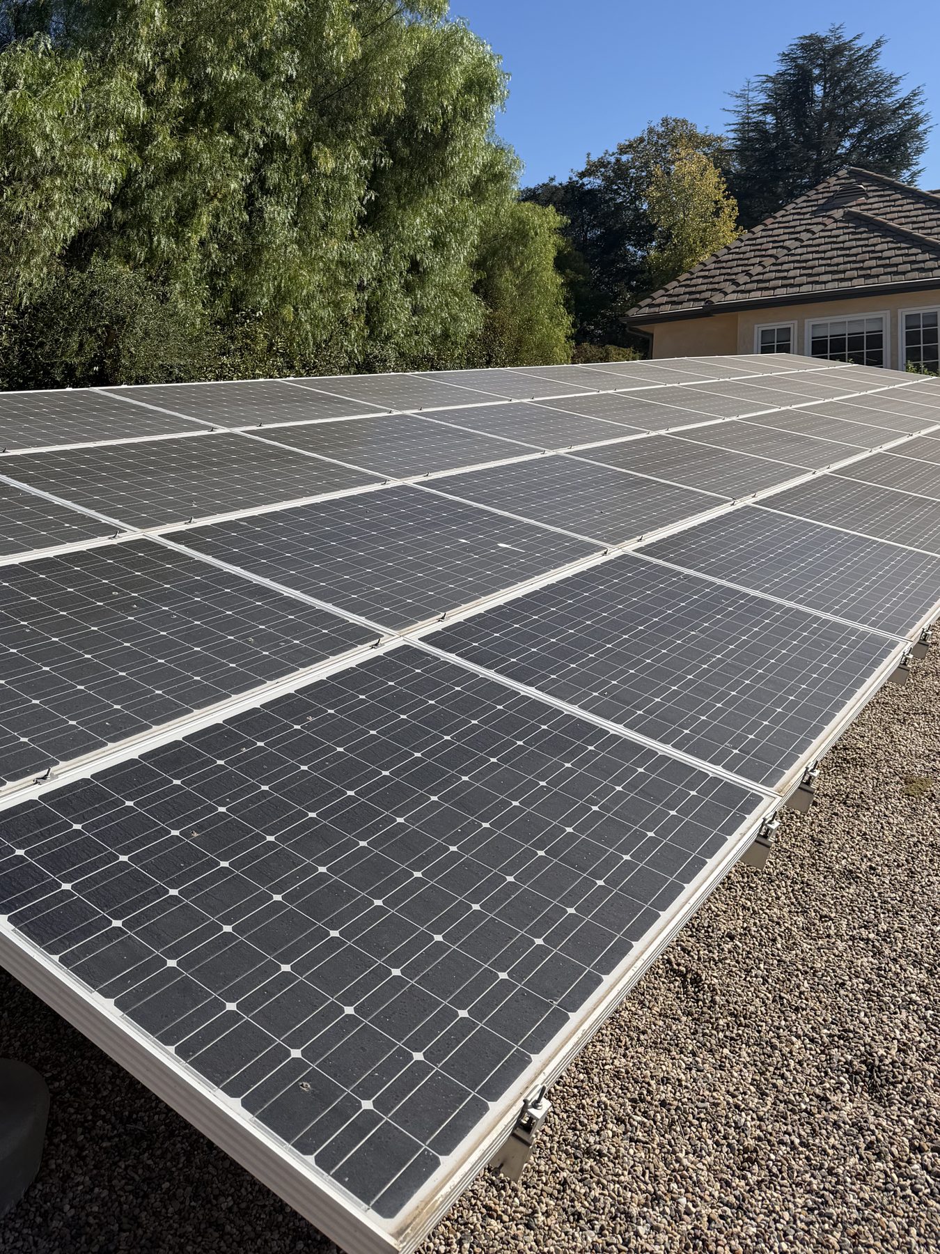 The same Ojai Valley solar array before cleaning, the panels dulled grey with dust.